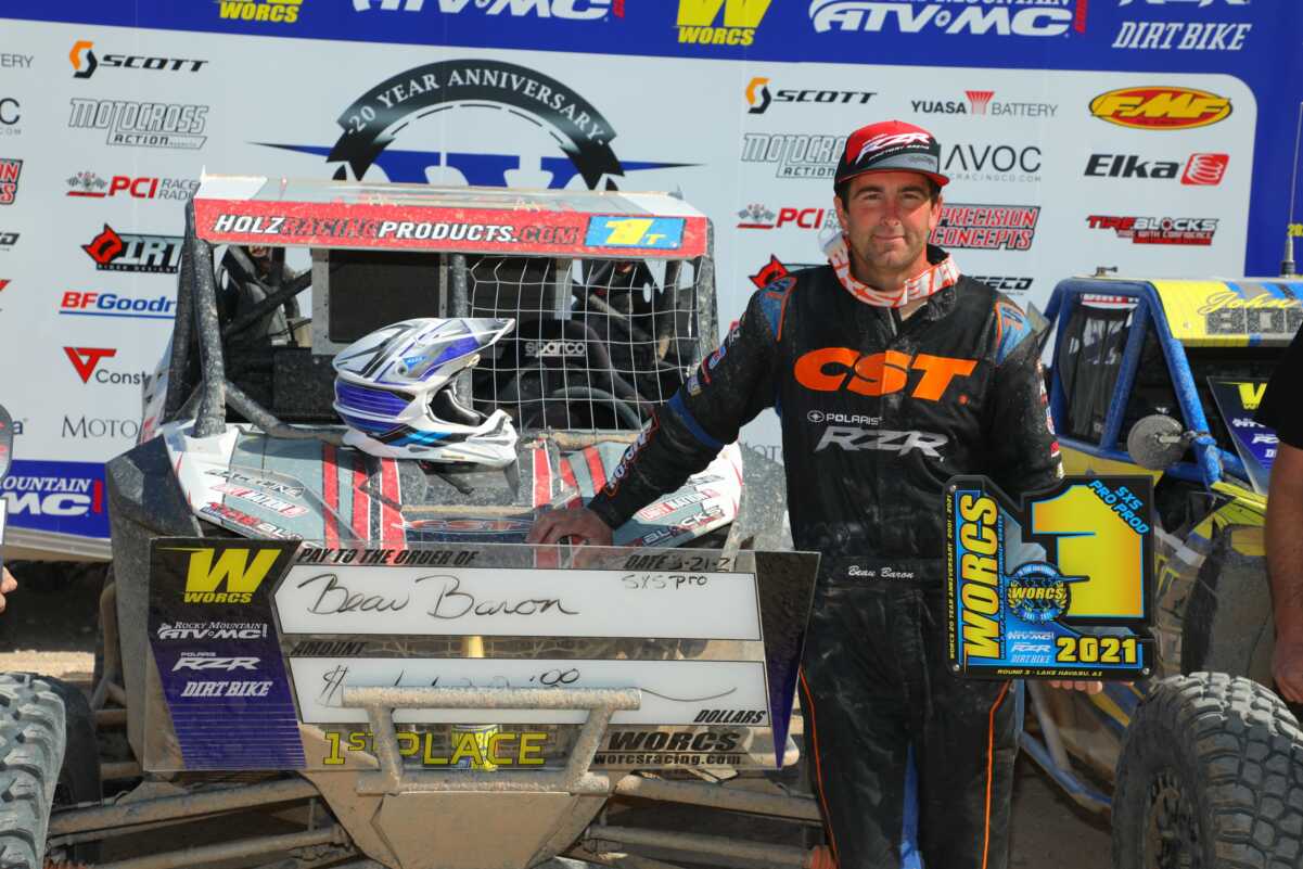 Car racer and his vehicle on the podium